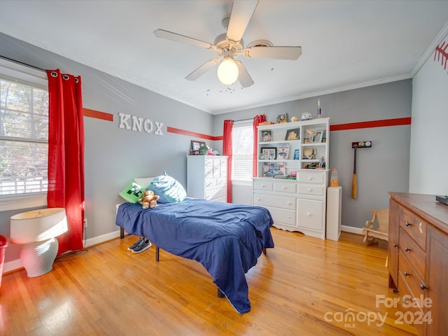 bedroom with light hardwood / wood-style floors, multiple windows, and ceiling fan