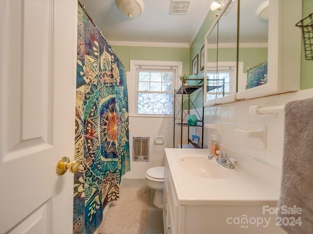 bathroom featuring tile patterned flooring, heating unit, toilet, vanity, and tile walls