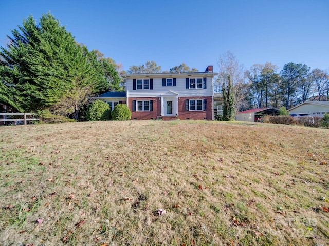 colonial-style house with a front yard