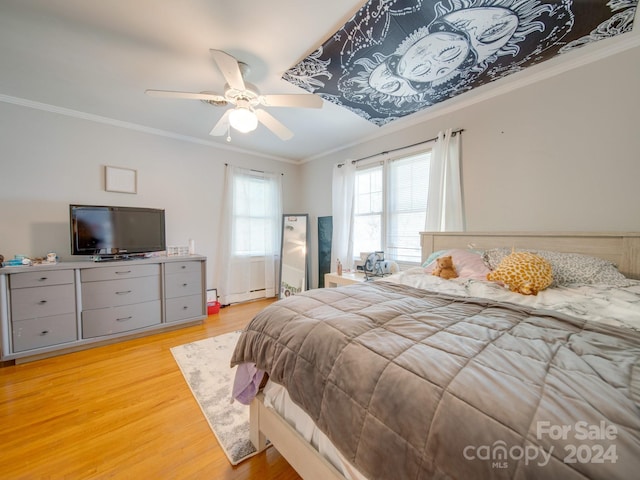 bedroom with baseboard heating, ceiling fan, ornamental molding, and light wood-type flooring