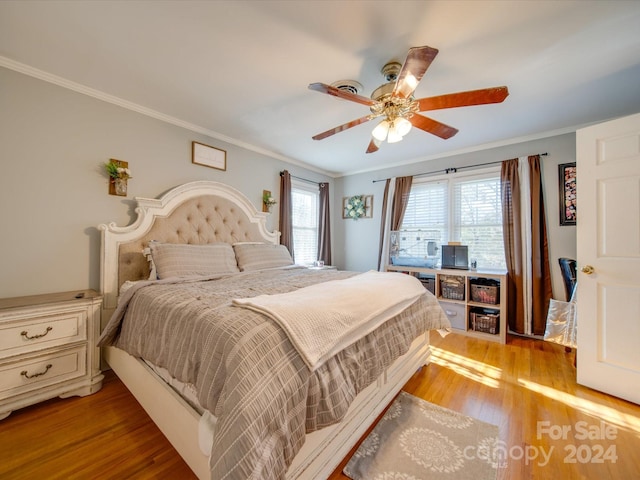 bedroom with light wood-type flooring, ceiling fan, and ornamental molding