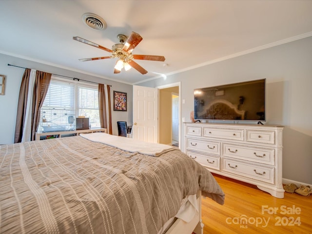 bedroom with light wood-type flooring, ceiling fan, and ornamental molding