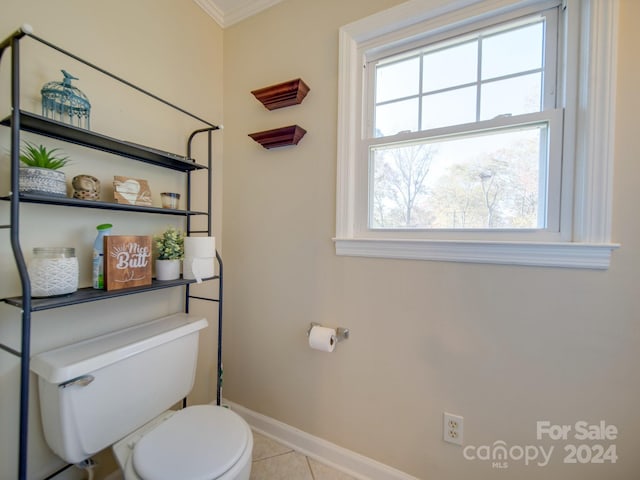 bathroom featuring tile patterned floors, toilet, and ornamental molding