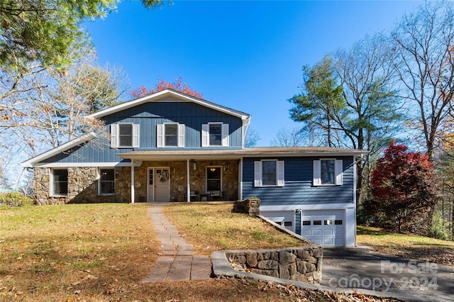 front of property with a front lawn and a garage