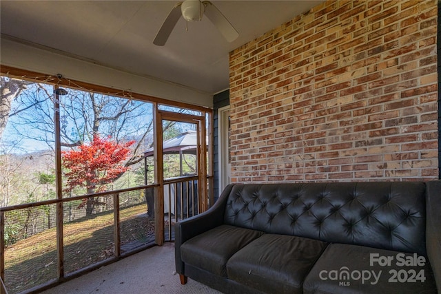 sunroom / solarium featuring ceiling fan