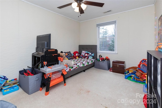 bedroom featuring ceiling fan, ornamental molding, and carpet floors