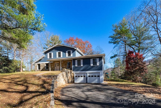 view of front of property with a front yard and a garage