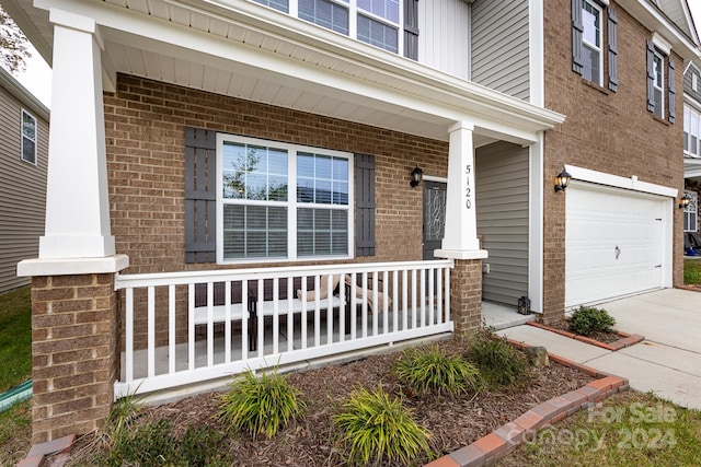 property entrance with covered porch and a garage