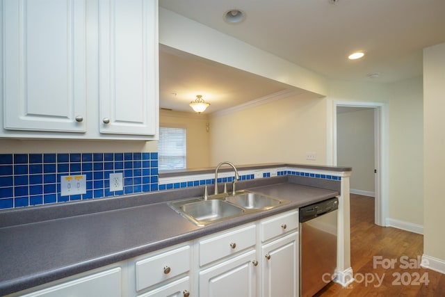 kitchen featuring sink, tasteful backsplash, dark hardwood / wood-style flooring, stainless steel dishwasher, and white cabinets