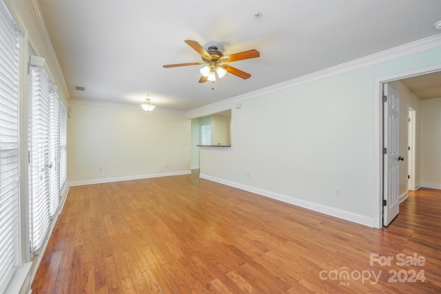 spare room with crown molding, light hardwood / wood-style flooring, and ceiling fan