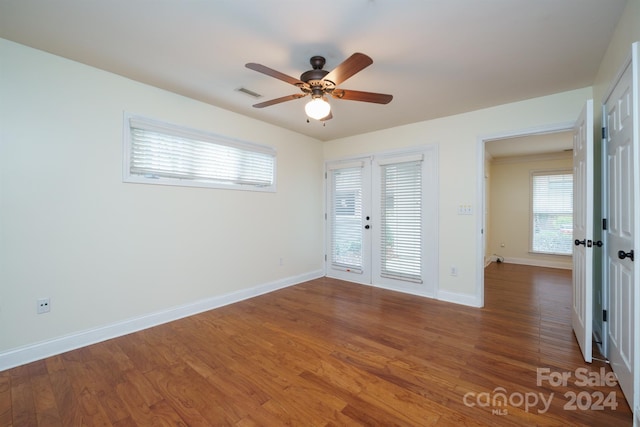 spare room with ceiling fan, dark wood-type flooring, and french doors