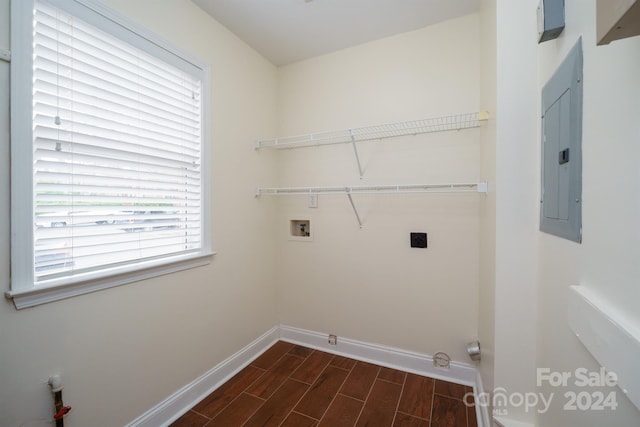 laundry room with electric dryer hookup, electric panel, dark hardwood / wood-style flooring, and hookup for a washing machine