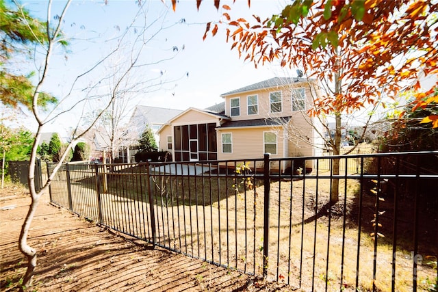 rear view of property with a sunroom