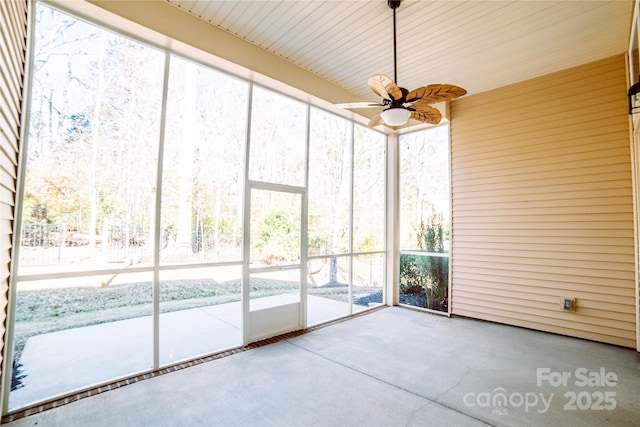 unfurnished sunroom with ceiling fan