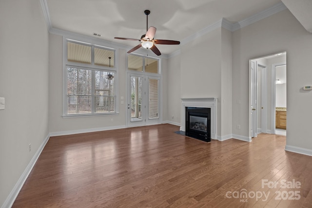 unfurnished living room featuring ceiling fan, hardwood / wood-style floors, and ornamental molding