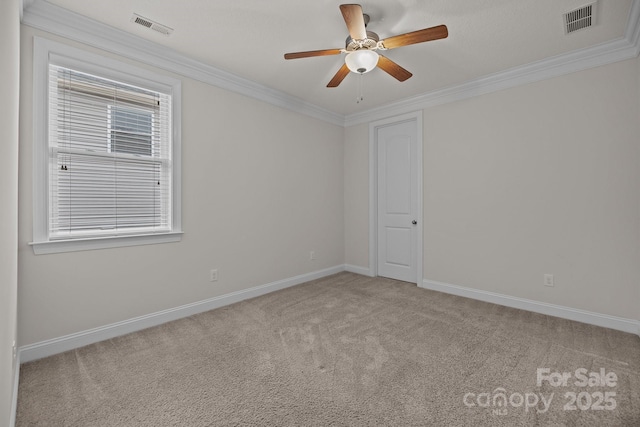 carpeted empty room with plenty of natural light, ornamental molding, and ceiling fan