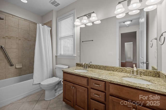 full bathroom with tile patterned flooring, shower / bath combination with curtain, vanity, and toilet