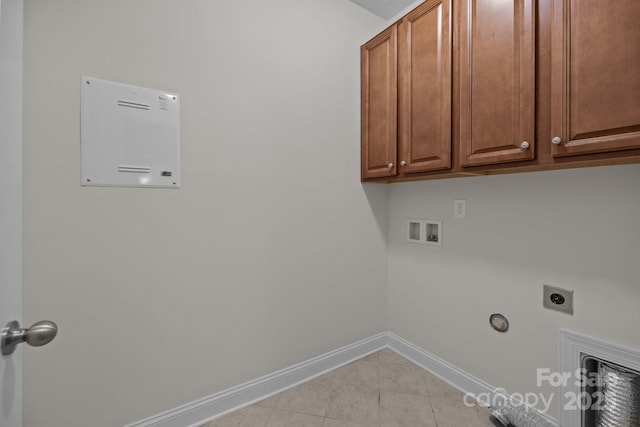 laundry room featuring washer hookup, electric dryer hookup, light tile patterned flooring, and cabinets