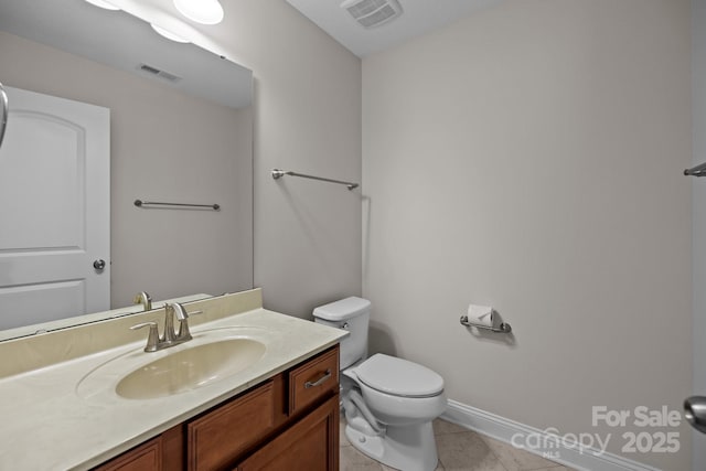 bathroom with tile patterned floors, vanity, and toilet