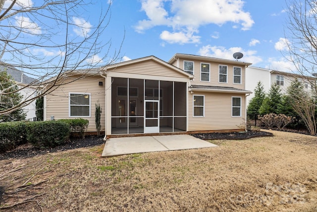 rear view of property with a patio, a sunroom, and a lawn