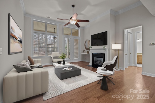 living room with ceiling fan, hardwood / wood-style floors, and ornamental molding