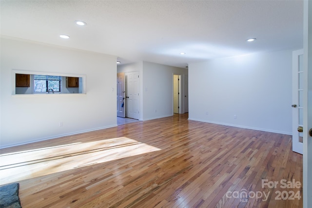 unfurnished living room with hardwood / wood-style floors