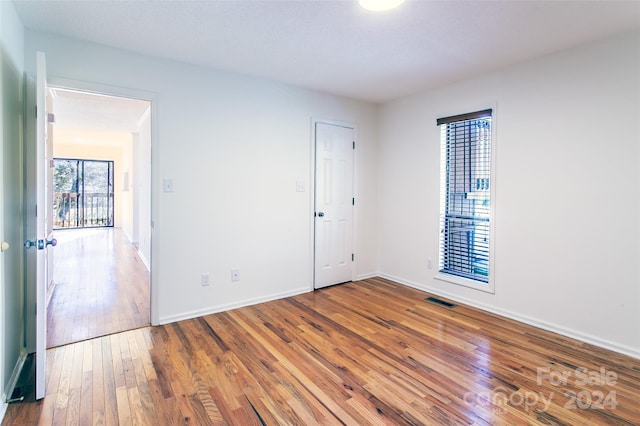 spare room with hardwood / wood-style floors