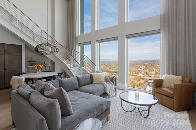 living room with a high ceiling and light hardwood / wood-style floors