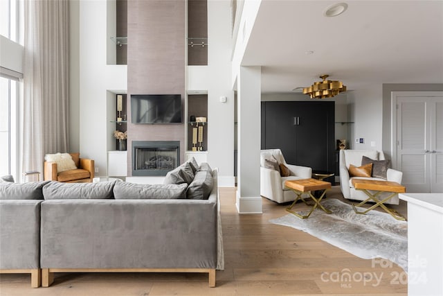 living room with a large fireplace and hardwood / wood-style floors