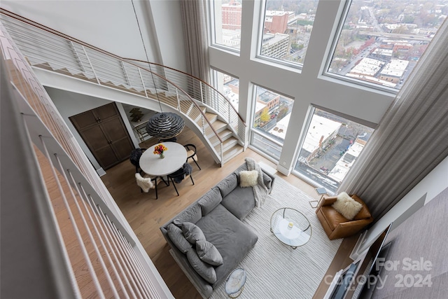 living room featuring hardwood / wood-style floors and a towering ceiling