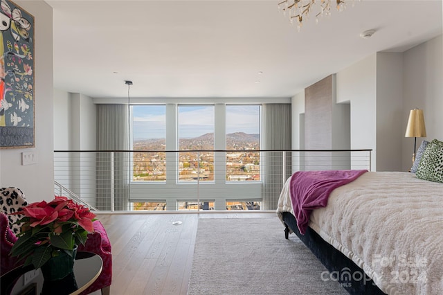 bedroom featuring a mountain view and wood-type flooring