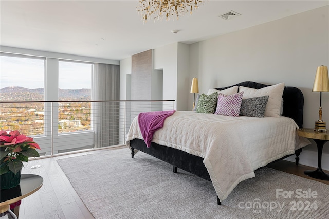 bedroom featuring a mountain view and wood-type flooring