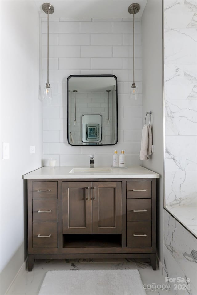 bathroom featuring vanity and tile walls