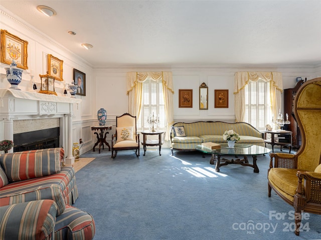 living room with carpet flooring, plenty of natural light, and ornamental molding