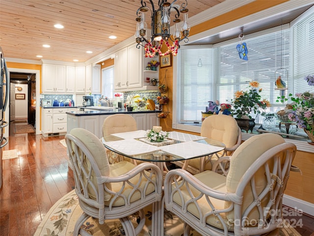 dining room with wooden ceiling, an inviting chandelier, sink, crown molding, and light hardwood / wood-style flooring