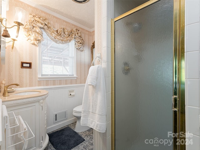 bathroom featuring crown molding, a textured ceiling, an enclosed shower, toilet, and vanity