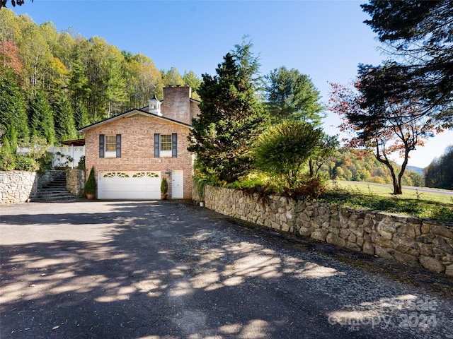 view of side of property featuring a garage