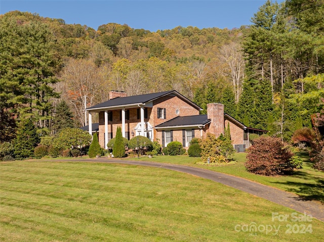 neoclassical home with a front lawn