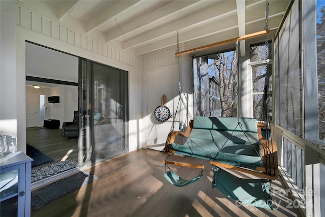 sunroom featuring beam ceiling