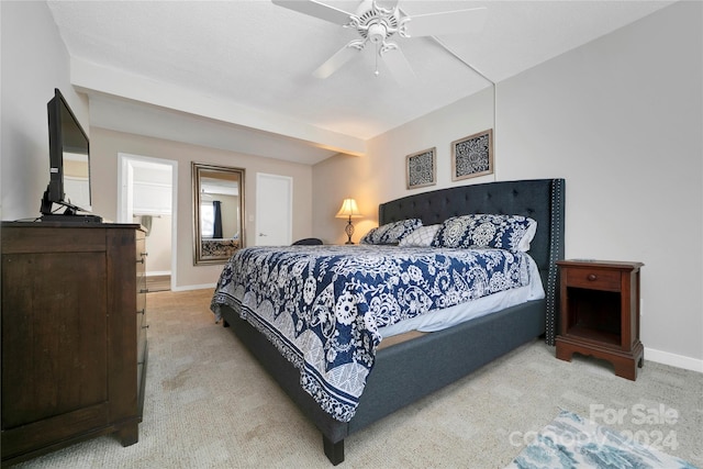 bedroom featuring ceiling fan and light carpet