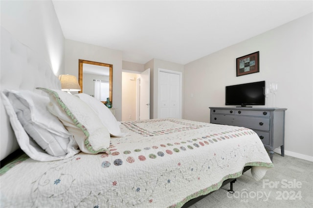 carpeted bedroom with a closet