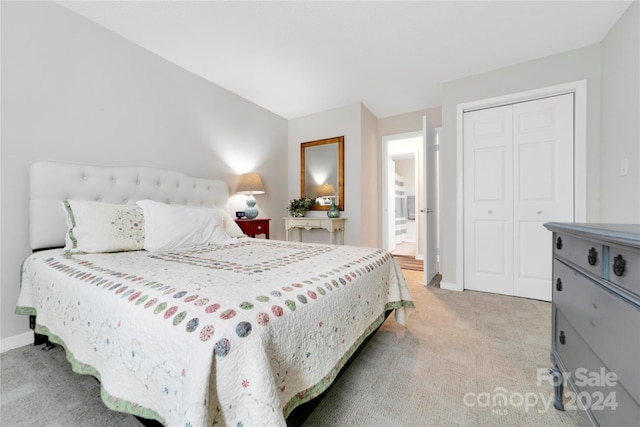 bedroom with light colored carpet and a closet