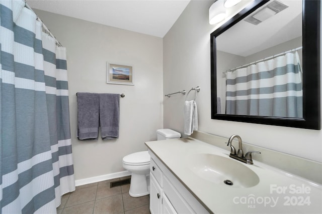 bathroom with walk in shower, tile patterned flooring, vanity, and toilet