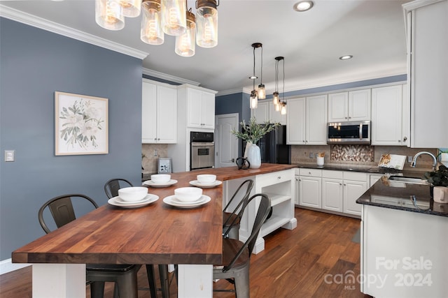 kitchen featuring white cabinetry, sink, dark wood-type flooring, butcher block countertops, and appliances with stainless steel finishes