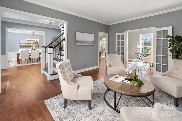 living room featuring french doors, dark hardwood / wood-style floors, and ornamental molding