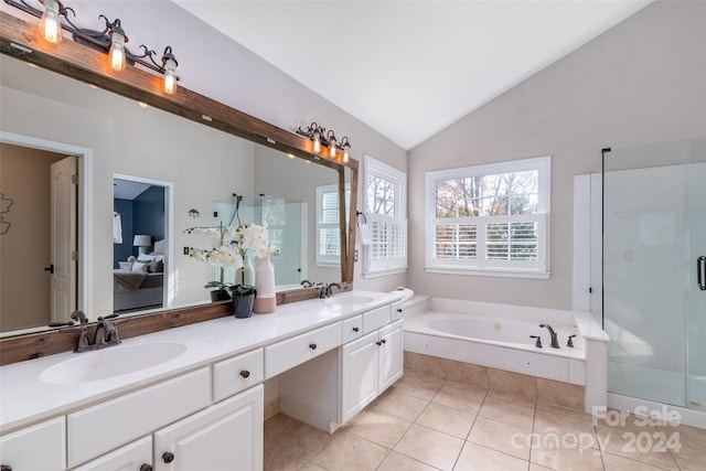 bathroom featuring plus walk in shower, tile patterned flooring, vanity, and lofted ceiling