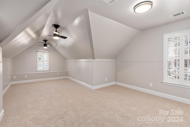 bonus room featuring light colored carpet, vaulted ceiling, and ceiling fan