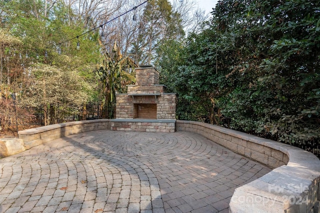 view of patio / terrace with an outdoor stone fireplace