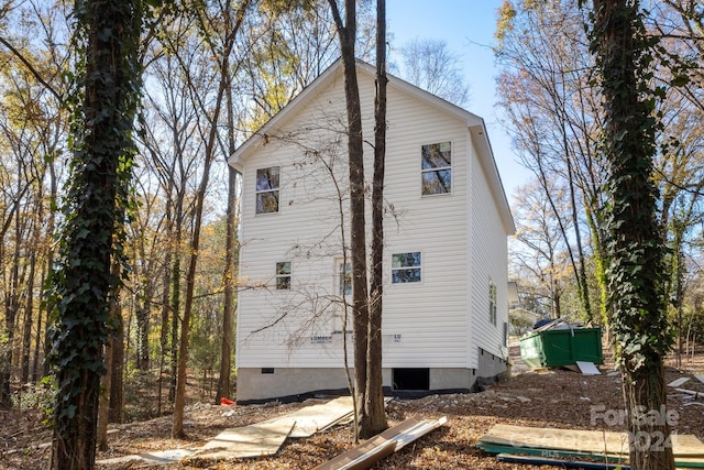 rear view of property with a storage shed