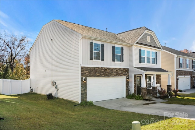 view of front of property with a garage and a front lawn